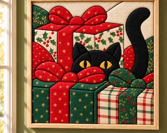 May include: A square fabric wall art piece featuring a black cat with yellow eyes peeking from behind stacked Christmas presents. The gifts are wrapped in red, green, and cream fabric with holly, plaid, and gold star patterns and large bows.