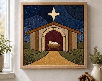 May include: A square framed fabric wall art piece depicting a nativity scene with a central manger, a dark red archway, and a large gold star against a navy blue starry sky, all set within a light wood frame.