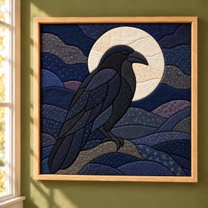 May include: A square fabric wall art piece featuring a dark blue and black raven perched on a branch against a large, cream-colored full moon. The background consists of layered, quilted blue fabric waves with subtle white patterns.