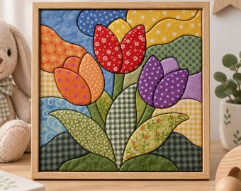 May include: A square framed fabric wall art piece featuring a quilted design of three tulips in red, orange, and purple. The flowers are surrounded by various patterned fabric sections in blue, yellow, and green, all encased in a light wood frame.