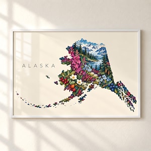 May include: A framed wall art print featuring the map of Alaska filled with a vibrant illustration of snow-capped mountains, evergreen trees, and colourful wildflowers including pink fireweed and berries. The word ALASKA is printed in black.