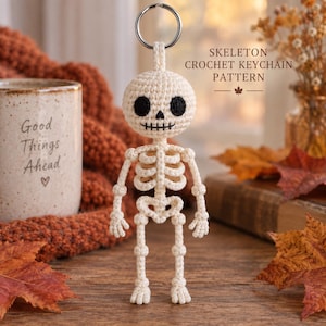 May include: A cream-colored crochet skeleton keychain featuring a round head with black embroidered eyes and a stitched mouth, a ribcage, and articulated limbs. The text SKELETON CROCHET KEYCHAIN PATTERN is visible in the upper right corner of the image.