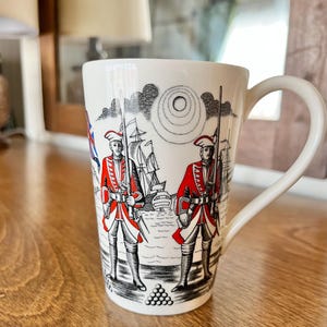 May include: A set of three ceramic mugs with a speckled, matte finish. The mugs are in shades of cream, light gray, and dark gray. Each mug has a simple, minimalist design, perfect for coffee or tea.