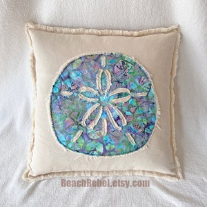 Sand dollar pillow cover with aqua, turquoise, and lavender batik on natural (off-white) denim 18&quot;