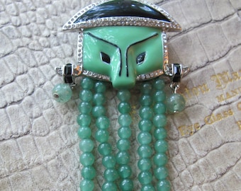 Oriental Mask Designer Fouquet Art Deco Museum Reproduction Brooch Pin, Chinese Asian Mask with Green Stone Bead Fringe, Enamel, Rhinestones