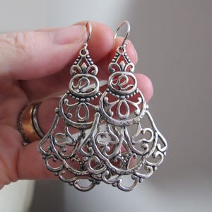 May include: A rustic wooden sign with the text "Welcome to our home" in white lettering. The sign features a distressed finish and a simple, inviting design, perfect for entryway decor.