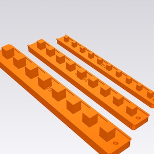 May include: Three orange rectangular organizers of varying lengths, each featuring a series of evenly spaced square protrusions along the top surface and a circular hole at one end for mounting purposes, arranged diagonally on a light background.