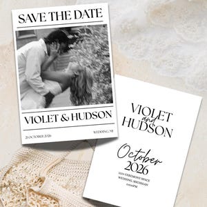 May include: Two rectangular white Save the Date cards with black text. One card features a black and white photo of a couple, the names Violet & Hudson, and the date 21 October 2026. The second card displays the names Violet and Hudson, October 2026, and location details.