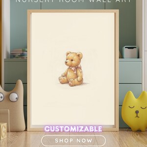 May include: A framed wall art print featuring a light brown teddy bear with a pink ribbon around its neck, centred on a cream background. The text NURSERY ROOM WALL ART, CUSTOMIZABLE, and SHOP NOW are visible on the image.