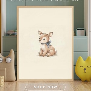 Nursery wall art mockup showing a vintage-style digital print of a cute fawn plush toy with a blue ribbon in a wooden frame, set against a cozy green and beige child's room background with toys.