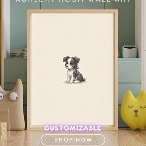 May include: A framed wall art print featuring a central illustration of a small black and white puppy wearing a light blue ribbon around its neck. The text NURSERY ROOM WALL ART, CUSTOMIZABLE, and SHOP NOW are visible on the image.