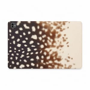 May include: A rectangular tablet case featuring a gradient pattern that transitions from a dark brown color on the left to a light cream color on the right. The surface is covered in a repeating pattern of small, irregular white spots.