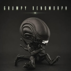 May include: A black Xenomorph figurine with a large, elongated head, white teeth, and arms crossed in a seated position. The text GRUMPY XENOMORPH is displayed in white capital letters above the figure against a dark, solid background.