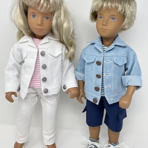 May include: Two dolls dressed in matching outfits. One doll wears a white jacket, pink striped shirt, and white pants. The other doll wears a blue denim jacket, striped shirt, and navy shorts. Both dolls have blonde hair and are wearing shoes.