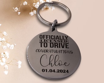 May include: Silver keychain with a round tag that says "Officially Licensed to Drive Congratulations Chloe 01.04.2024".
