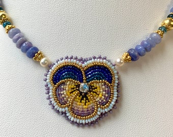beaded pansy necklace by Nome May micro bead embroidery, blue and yellow and lavender with pearls and hackmanite