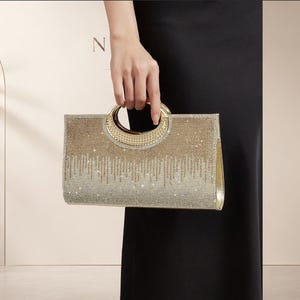 Gouden strass clutch met ronde handgreep, sprankelende avondtas