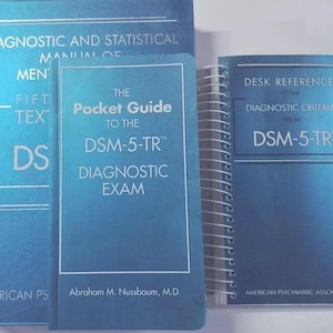 May include: Three blue books including the Diagnostic and Statistical Manual of Mental Disorders Fifth Edition Text Revision, The Pocket Guide to the DSM-5-TR Diagnostic Exam by Abraham M. Nussbaum, and the Desk Reference to the Diagnostic Criteria from DSM-5-TR.