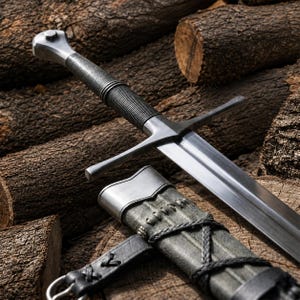 May include: A steel sword with a straight crossguard and a ribbed grip, featuring a metallic pommel. The blade is double-edged and tapers to a point. It is accompanied by a dark grey leather scabbard with black cord lacing and a metal buckle.