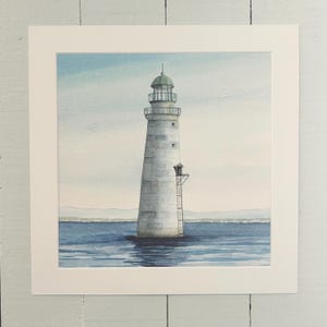 May include: Watercolor painting of a lighthouse in the sea. The lighthouse is white with a green top and a ladder on the side. The sea is blue, and the sky is a light blue. The painting is framed in a white mat.