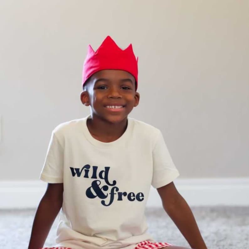 little boy wearing red kids crown for birthdays