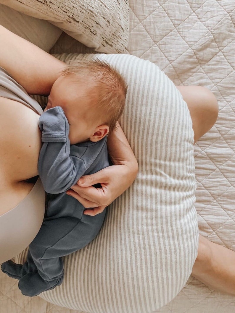 mom nursing a newborn on a breastfeeding pillow