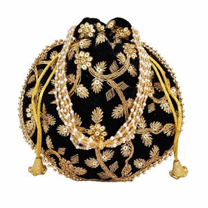 May include: A black velvet drawstring pouch featuring intricate gold thread embroidery, sequin floral accents, and a beaded handle made of multiple strands of white faux pearls. The bag includes yellow cord drawstrings with gold-toned metal tassels.