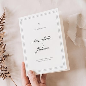 Könnte beinhalten: Eine weiße Hochzeitseinladungskarte mit einem Doppellinienrahmen und schwarzer Serifenschrift. Der Text lautet A|J, THE WEDDING OF, Annabelle AND Julian, Wednesday, November 17, 2027, CHARLOTTESVILLE, VA. Die Karte ist rechteckig mit klaren Kanten.