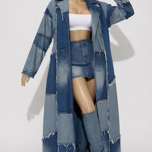 Pode incluir: Um casaco comprido de ganga estilo patchwork com vários tons de azul e bordas desfiadas. O casaco é usado sobre uma minissaia de ganga a condizer e um top bandeau branco liso, combinado com botas de ganga até ao joelho.