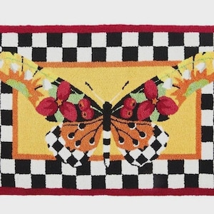 May include: A rectangular rug featuring a central yellow panel with a large butterfly graphic. The butterfly has orange, red, and black wings with white accents. The rug is bordered by a black and white checkered pattern and a solid red outer edge.