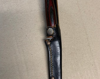 1950’s Unbranded Reddish Grained Wood handle 7” hunting knife/black leather sheath