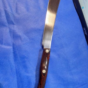 May include: A set of three ceramic mugs with a speckled, matte finish. The mugs are in shades of cream, light gray, and dark gray. Each mug has a simple, minimalist design and a rounded handle.