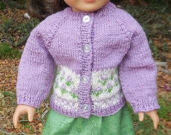 Hand knit, lavender sweater with flower design, matching tam, and a green skirt, made to fit American Girl and similar 18 inch dolls.