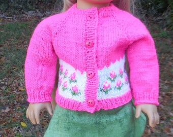 Hand knitted, pink sweater with a beret and a green A-line skirt made to fit American Girl and similar 18 inch dolls.