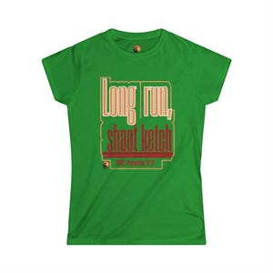 May include: A bright green short-sleeve t-shirt featuring a graphic print with the text "Long run, shaat ketch" in a layered font style, with the additional text "POV: Proverbs 11:21" printed below in a smaller font size on the front center.