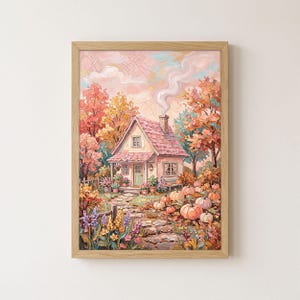 May include: A framed wall art print featuring an oil painting of a cottage with a pink roof and chimney smoke. The scene includes a stone path, autumn trees in shades of orange and yellow, and orange pumpkins scattered across the front yard.