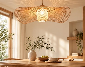 May include: A wide, woven bamboo pendant light fixture with a flared, hat-like silhouette and a central cylindrical shade. The natural light-brown material creates intricate patterns of light and shadow on the ceiling when illuminated.