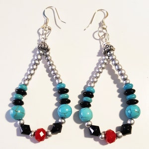 May include: A pair of silver teardrop-shaped earrings with turquoise, black, and red beads.
