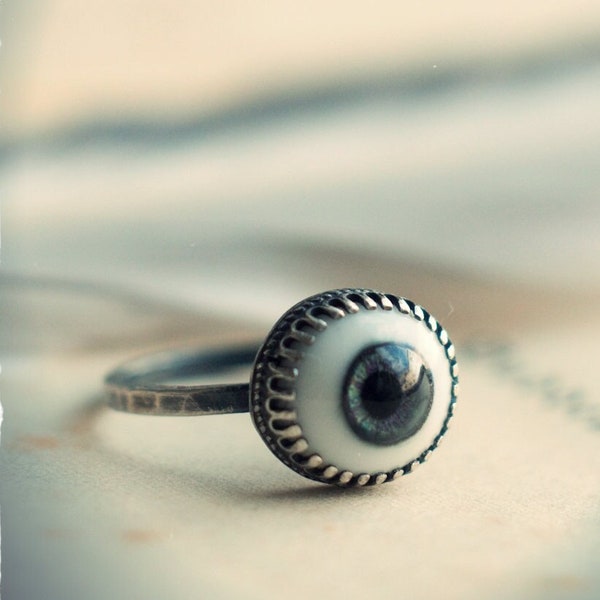 Sterling silver evil eye ring with a realistic human glass dolls eye. A protection amulet for witchy folk in blue, green, grey, and brown.