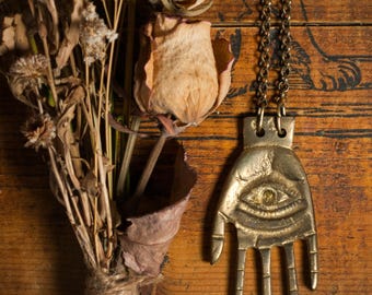 Statement necklace with hamsa hand on a chunky brass belcher chain, a gender neutral protection amulet.