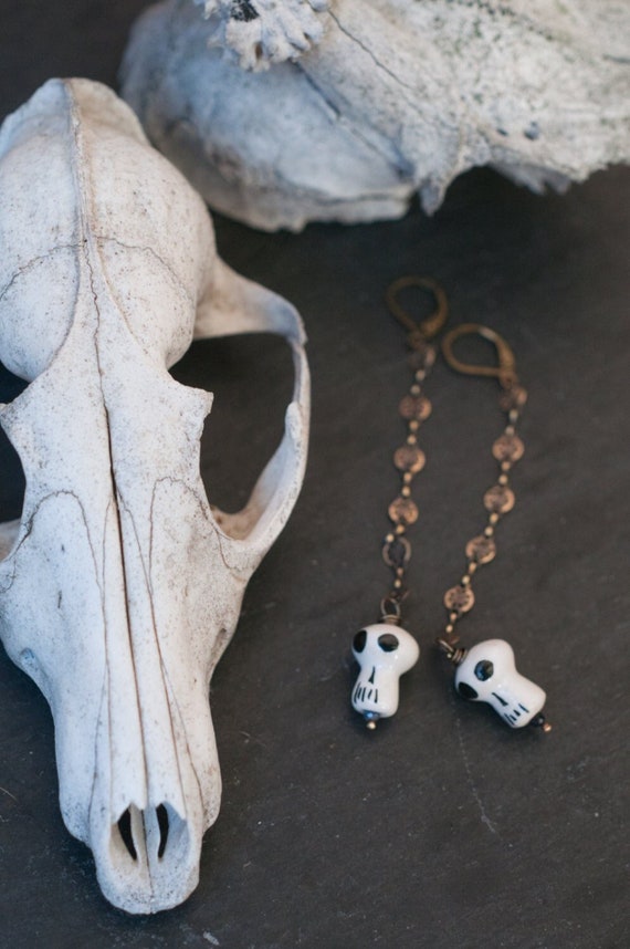 Little skull earrings, brass shoulder dusters with filigree coin link chain and ceramic skull beads, vegan bone jewellery, witchy gift.