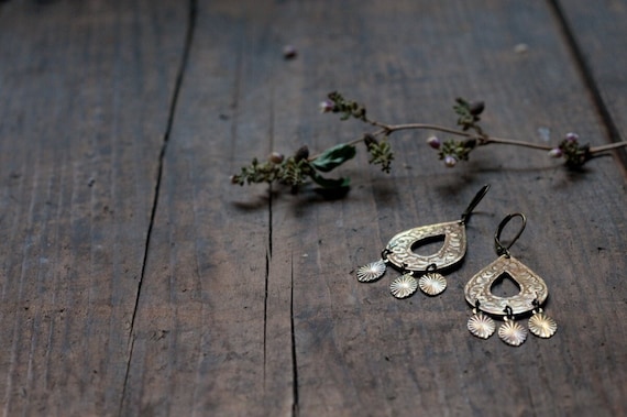 Brass chandelier teardrop earrings with a rainbow patina.