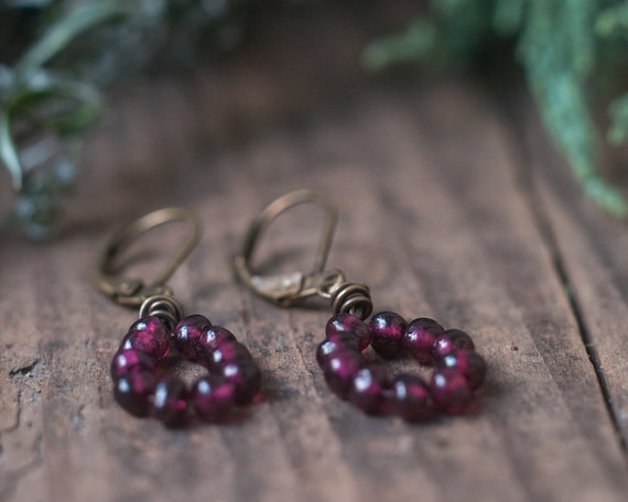 Little garnet wire wrapped drop earring with antiqued brass