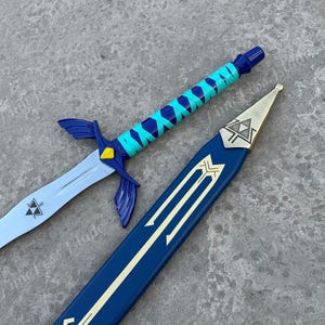 May include: A sword and its matching scabbard. The sword features a silver blade with a small triangular emblem, a dark blue crossguard with wing-like extensions, and a handle wrapped in bright turquoise and dark blue ribbon with a yellow accent.