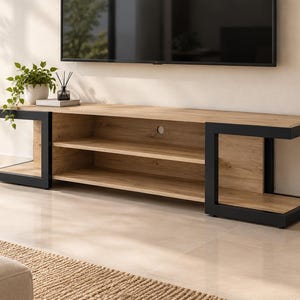 May include: A long rectangular media console featuring a light oak wood grain finish with two open shelves and a central circular cable management hole, supported by two thick black metal U-shaped frames on each end.