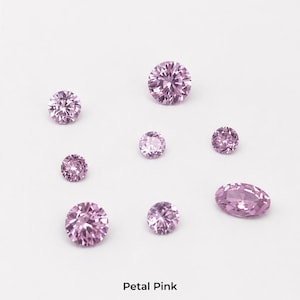 Eight faceted pink stones on a pale grey background: three 2.5 mm rounds,
two 3 mm rounds, two 4 mm rounds and one 4 x 6 mm oval, shown loose so the
pink blush colour is visible. Labelled petal pink.