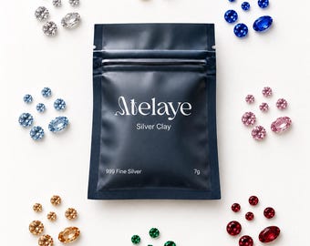 May include: A dark blue pouch labeled Atelaye Silver Clay 999 Fine Silver 7g, surrounded by eight circular clusters of faceted gemstones in various colors including yellow, blue, pink, red, green, light blue, clear, and amber tones.