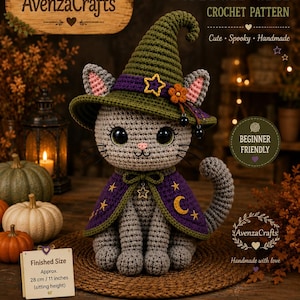 May include: A grey crocheted cat wearing a green witch hat with a purple band, a star, and a flower, and a purple cape with gold stars and a moon. The cat has large black eyes, a pink nose, and whiskers. A sign indicates a finished size of 28 cm.