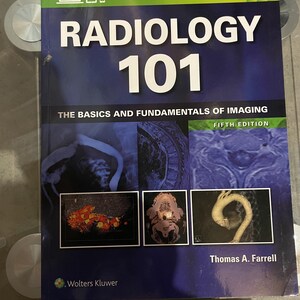 May include: A textbook titled Radiology 101: The Basics and Fundamentals of Imaging, Fifth Edition by Thomas A. Farrell. The cover is dark blue with white text and features six various medical diagnostic images, including scans and anatomical views.
