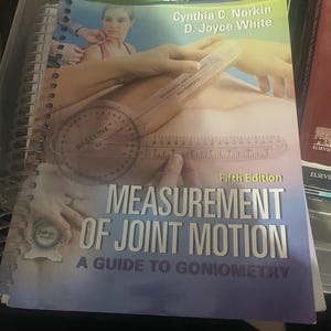 May include: A spiral-bound textbook titled Measurement of Joint Motion: A Guide to Goniometry, Fifth Edition, by Cynthia C. Norkin and D. Joyce White. The cover features a photograph of a clear plastic goniometer being used on a human arm.